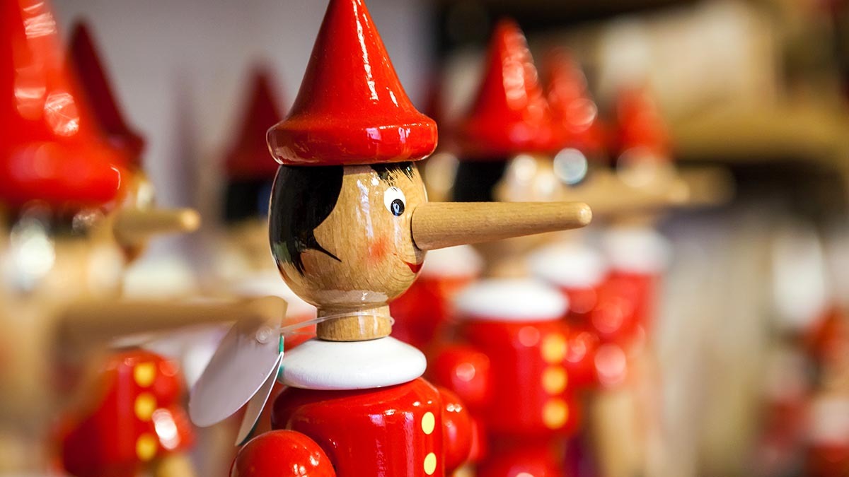 A shelf of Pinocchio toys with long noses