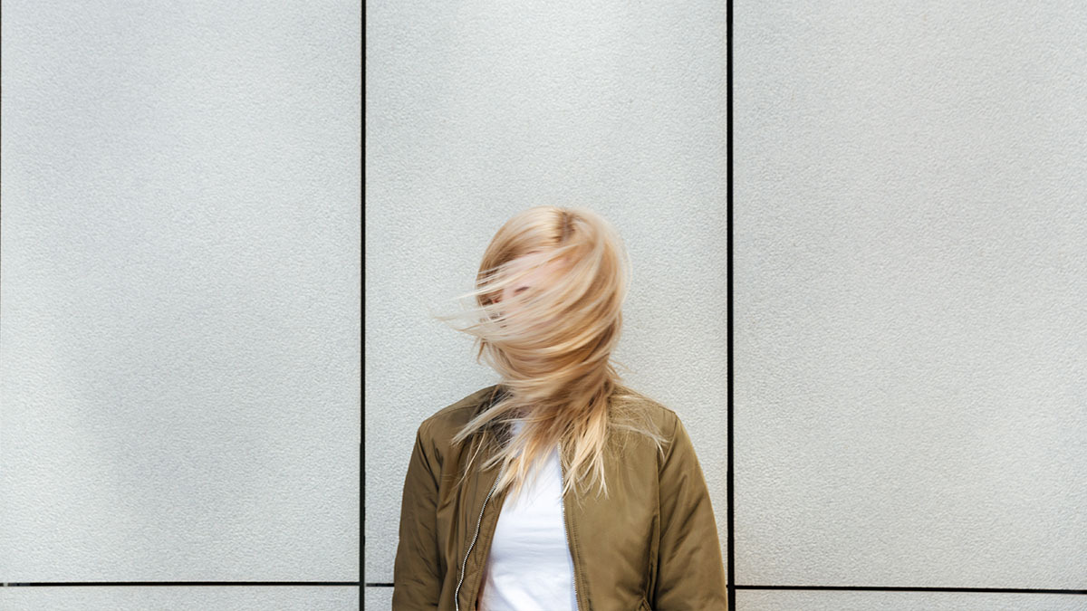 A woman's hair blows in front of her face