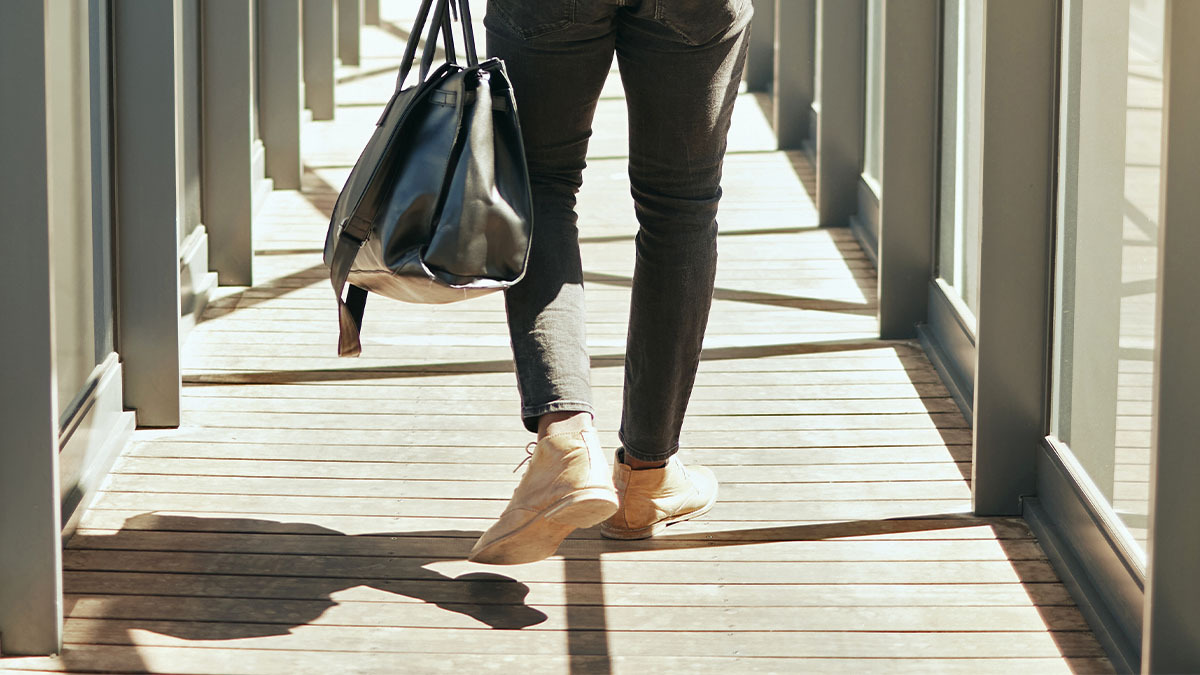 A man walks away with a packed bag