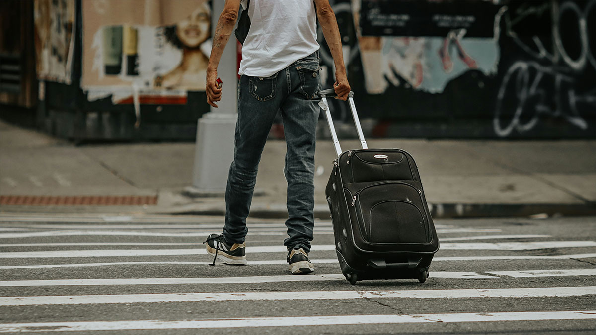 A man walks away with a packed bag