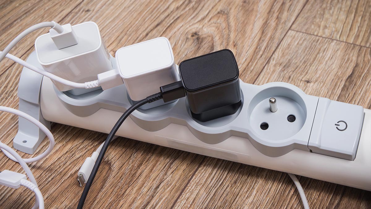 Many phone chargers are plugged into a power strip