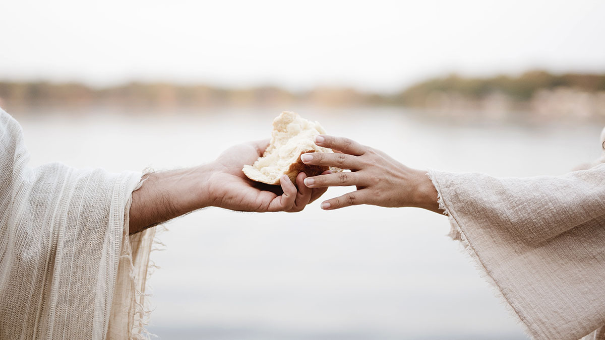 Jesus Christ hands a woman a piece of bread
