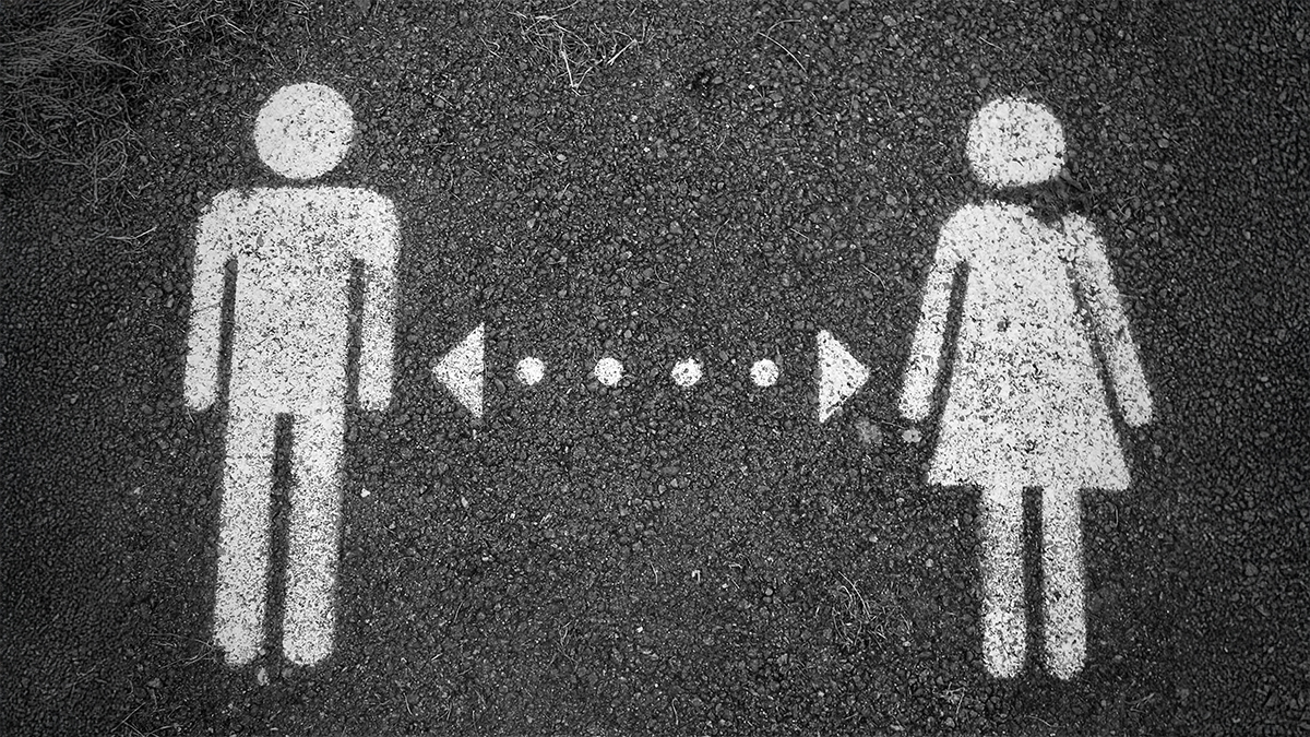 Male and female icons spray painted onto the ground
