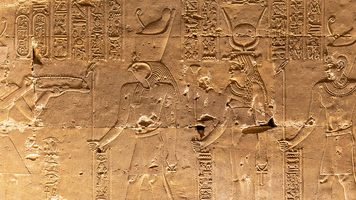 A wall of hieroglyphs in Egypt, featuring Egyptian gods