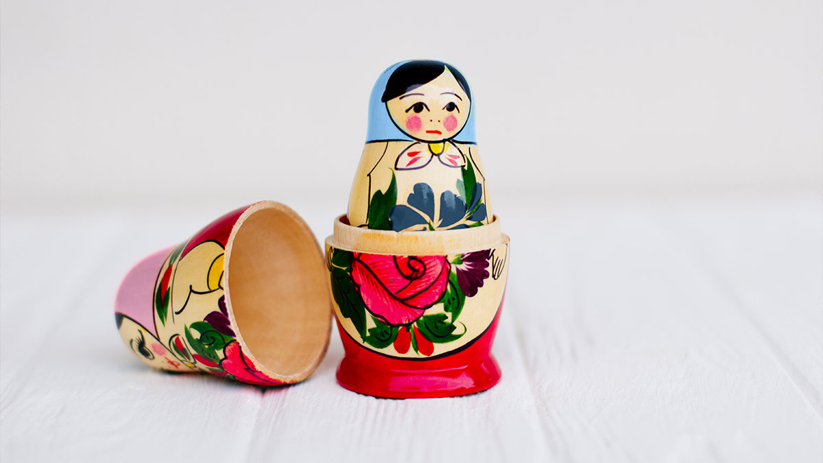 A boy nesting doll is revealed within a girl nesting doll