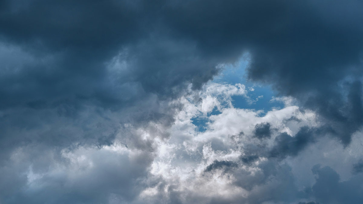 Dark clouds hide the blue sky