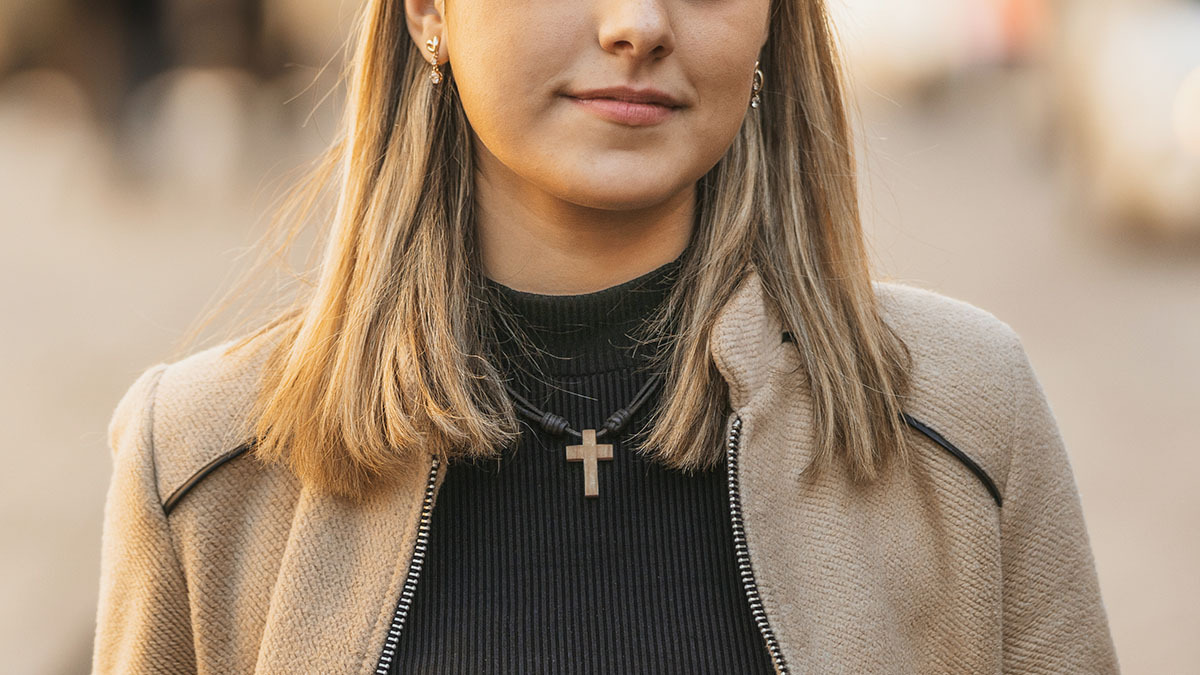 A woman wearing a cross necklace