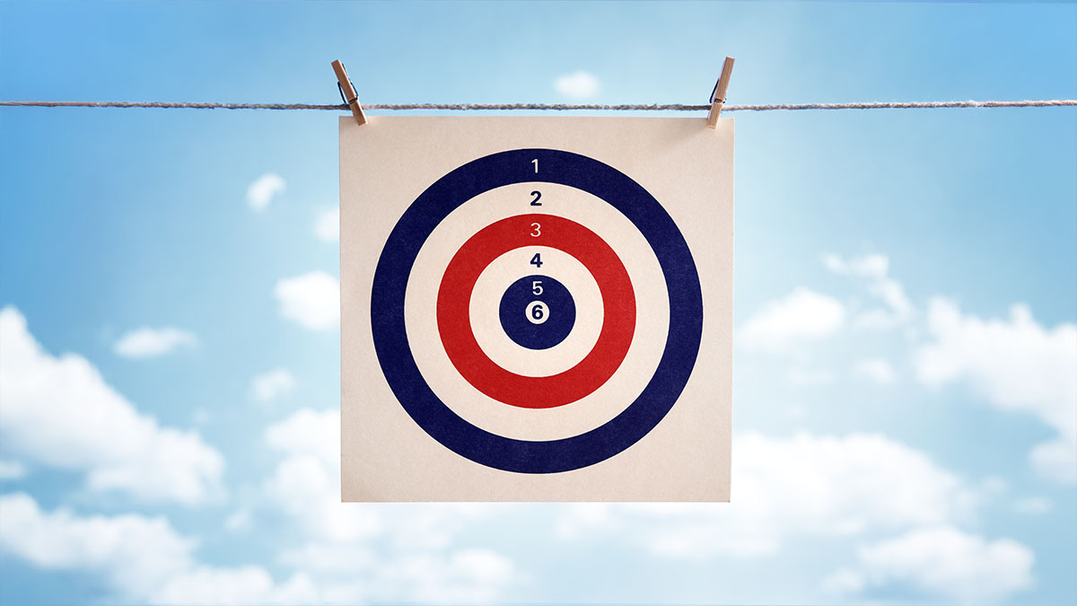 A target bullseye hangs on a string, the sky is in the background