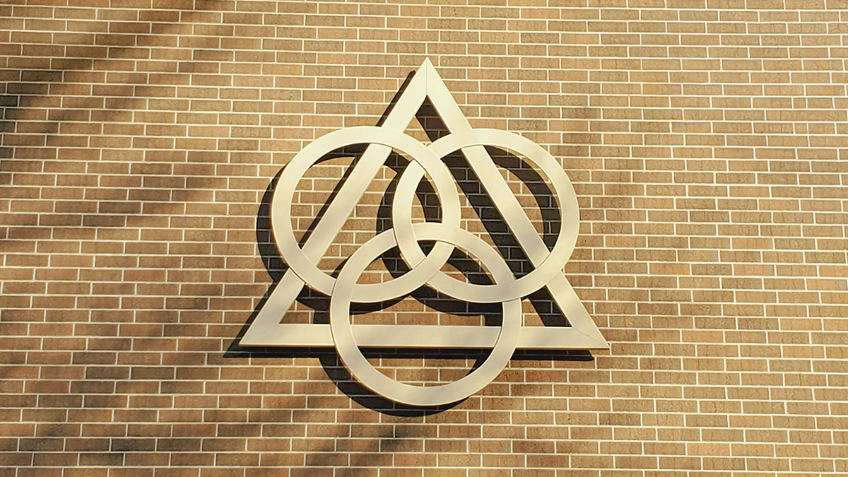 A symbol representing the Trinity on a brick wall